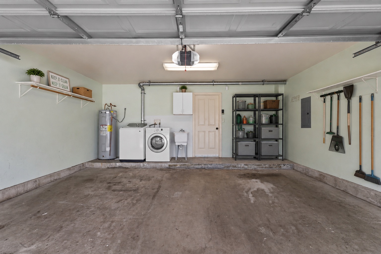 Two-car enclosed garage with laundry area and storage