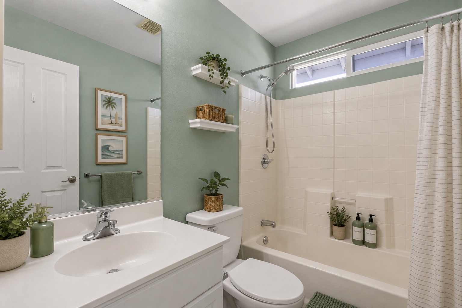 Second full bath with soft green walls and tub-shower